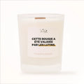 Bougie parfumée Les Fées Mères avec l'étiquette « Cette bougie a été validée par les lutins », pot blanc et mèche en bois de hêtre