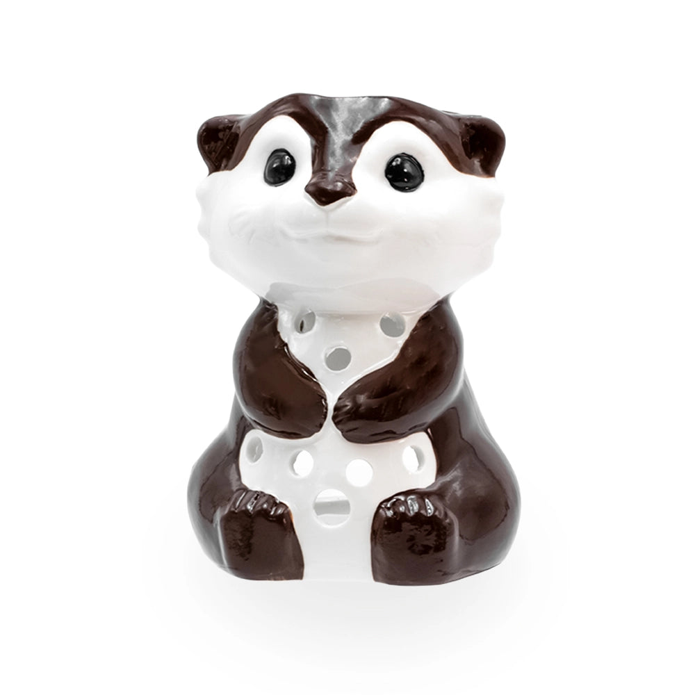 Brûle parfum loutre en céramique marron et blanche aux grands yeux brillants, ajours ronds sur le ventre, Les Fées Mères