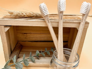 Brosse à dents pour enfants écologique en bois de hêtre. Les brosses à dents sont présentées dans un pot en verre.